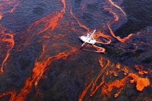 A shrimp boat is used to collect oil with booms in the waters of Chandeleur Sound, La., Wednesday, May 5, 2010. (AP Photo/Eric Gay) Original Filename: AP100505022655.jpg